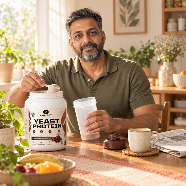 A man at breakfast scooping EVRYDAY Yeast Protein