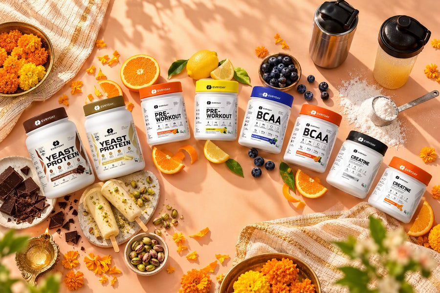 All eight EVRYDAY tubs on a peach table with flavour props
