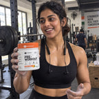 Customer holding EVRYDAY Pre-Workout - Orange